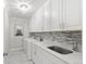 Well lit laundry room with modern appliances, white cabinetry, and marble floors at 2518 N State Highway 67, Sedalia, CO 80135