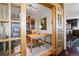 A cozy office space with natural lighting, wood floors and a wooden bookcase at 2518 N State Highway 67, Sedalia, CO 80135