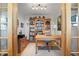 A cozy office with a large wooden bookcase and a light colored carpet at 2518 N State Highway 67, Sedalia, CO 80135