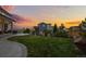 Well-manicured backyard with a covered patio, a manicured lawn, and decorative landscaping at 6696 Kenzie Cir, Castle Pines, CO 80108