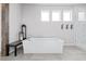 A bathroom with a soaking tub, a shower with marble tile, a dark bench and hardware at 6696 Kenzie Cir, Castle Pines, CO 80108