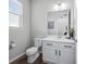 Bright bathroom features a vanity with modern fixtures, a framed mirror, and a wood-look floor at 6696 Kenzie Cir, Castle Pines, CO 80108