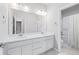 A bright bathroom features a double vanity with undermount sinks and white cabinets at 6696 Kenzie Cir, Castle Pines, CO 80108