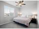 A cozy bedroom features a ceiling fan, plush bedding, and natural light at 6696 Kenzie Cir, Castle Pines, CO 80108