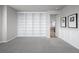 Versatile bonus room featuring a built-in bookcase for storage and display with neutral carpet at 6696 Kenzie Cir, Castle Pines, CO 80108