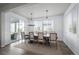 Formal dining room with designer chandelier, and neutral color palette adjacent to an outside patio at 6696 Kenzie Cir, Castle Pines, CO 80108