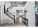 Grand entryway showcasing a staircase, hardwood floors, and a console table with elegant decor at 6696 Kenzie Cir, Castle Pines, CO 80108