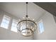 Elegant foyer featuring a statement chandelier, a soaring ceiling, and large windows for natural light at 6696 Kenzie Cir, Castle Pines, CO 80108