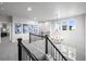 Upstairs hallway features decorative railing and a modern chandelier at 6696 Kenzie Cir, Castle Pines, CO 80108