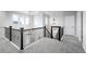 Upstairs hallway features decorative railing, a view to downstairs and a modern chandelier at 6696 Kenzie Cir, Castle Pines, CO 80108