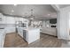 Spacious kitchen featuring an island, modern appliances, and seamless flow to the living area at 6696 Kenzie Cir, Castle Pines, CO 80108