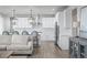Modern kitchen with white cabinets, stainless steel appliances, and pendant lighting over the island at 6696 Kenzie Cir, Castle Pines, CO 80108