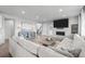 Spacious living room featuring a fireplace, large sectional, and seamless flow to the staircase at 6696 Kenzie Cir, Castle Pines, CO 80108