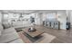 Bright living room featuring a large sectional, modern decor, and seamless flow to the kitchen at 6696 Kenzie Cir, Castle Pines, CO 80108
