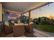 Inviting covered outdoor patio with comfortable seating and string lights for relaxing evenings at 6696 Kenzie Cir, Castle Pines, CO 80108
