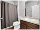 Bathroom featuring a dark gray shower curtain, wooden floors, a toilet, and a white sink at 5842 High Timber Cir, Castle Rock, CO 80104