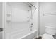 Bathroom with a shower-tub combo and white tile walls for a clean and simple feel at 5842 High Timber Cir, Castle Rock, CO 80104