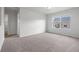 Spacious bedroom with neutral decor, plush carpeting and a large window providing natural light and neighborhood views at 5842 High Timber Cir, Castle Rock, CO 80104
