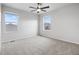 Spacious, bright bedroom with neutral paint, plush carpet, ceiling fan and a window with neighborhood views at 5842 High Timber Cir, Castle Rock, CO 80104