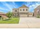 Charming two-story home features a three-car garage, stone accents, a well-manicured lawn, and a welcoming front porch at 5842 High Timber Cir, Castle Rock, CO 80104