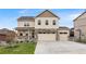 Charming two-story home featuring a stone facade, three-car garage, and a well-kept lawn at 5842 High Timber Cir, Castle Rock, CO 80104