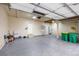Attached two car garage with epoxy flooring, storage cabinets, and overhead lighting at 5842 High Timber Cir, Castle Rock, CO 80104