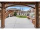 Covered wooden gazebo with outdoor seating, providing a view of the backyard at 5842 High Timber Cir, Castle Rock, CO 80104