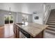 Kitchen with granite countertops, an island with seating, and a view into the living area and the back deck at 5842 High Timber Cir, Castle Rock, CO 80104