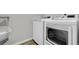 A laundry room with a white washing machine, white dryer, and white storage cart at 5842 High Timber Cir, Castle Rock, CO 80104