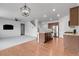 Open-concept living space with hardwood floors, kitchen, a staircase, and modern lighting fixtures at 5842 High Timber Cir, Castle Rock, CO 80104
