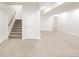 Finished basement with neutral carpet, white walls, stairs, and multiple doors at 6700 W Dorado Dr # 41, Littleton, CO 80123