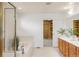 Elegant bathroom featuring double vanities, a soaking tub, tiled floors, and a well-organized walk-in closet at 6700 W Dorado Dr # 41, Littleton, CO 80123