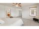 Spacious bedroom with a ceiling fan, a window with wood blinds, and open doorways offering seamless flow at 6700 W Dorado Dr # 41, Littleton, CO 80123