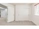 Carpeted bedroom featuring a double door closet and natural light from a window at 6700 W Dorado Dr # 41, Littleton, CO 80123