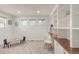 Bright bonus room with built-in bookshelves, modern chair and furniture, perfect for a playroom or home office at 6700 W Dorado Dr # 41, Littleton, CO 80123