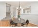 Cozy dining room featuring hardwood floors, and a modern chandelier over a round table with upholstered chairs at 6700 W Dorado Dr # 41, Littleton, CO 80123