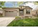 Charming two-story home featuring a two-car garage and well-manicured front yard with lawn and flower beds at 6700 W Dorado Dr # 41, Littleton, CO 80123