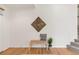 Bright foyer featuring hardwood floors, a bench with pillow and decor and an open layout to a stairwell at 6700 W Dorado Dr # 41, Littleton, CO 80123
