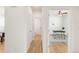 Bright hallway leading to an office with hardwood floors, a ceiling fan, and a gray and white rug at 6700 W Dorado Dr # 41, Littleton, CO 80123