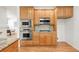 Modern kitchen featuring built-in microwave, stainless steel appliances, and gas cooktop at 6700 W Dorado Dr # 41, Littleton, CO 80123