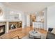 Open living room with fireplace, hardwood flooring and view to the kitchen at 6700 W Dorado Dr # 41, Littleton, CO 80123