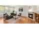 Comfortable living room featuring hardwood floors, a fireplace, and a neutral-toned couch with bright windows at 6700 W Dorado Dr # 41, Littleton, CO 80123