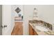 Close-up view of a modern powder room with a stylish granite countertop and wood-finished cabinets at 6700 W Dorado Dr # 41, Littleton, CO 80123