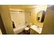 Bathroom features a shower-tub combo, clean white tile, and vanity at 14102 E Colorado Dr # 102, Aurora, CO 80012