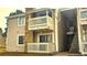Inviting condo featuring stone accents, two balconies, and well-maintained siding at 14102 E Colorado Dr # 102, Aurora, CO 80012