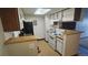Functional kitchen features white appliances, ample cabinet space, and a bright skylight at 14102 E Colorado Dr # 102, Aurora, CO 80012