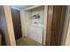 Convenient laundry area features side-by-side washer and dryer and shelving at 14102 E Colorado Dr # 102, Aurora, CO 80012