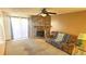 Cozy living room with stone fireplace, neutral carpet, and natural light at 14102 E Colorado Dr # 102, Aurora, CO 80012