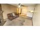 Open living area featuring neutral carpet, fireplace, and easy access to kitchen and dining at 14102 E Colorado Dr # 102, Aurora, CO 80012