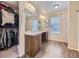 Bathroom with double sink vanities, walk in closet, wood look flooring, and natural light at 2508 Coach House Loop, Castle Rock, CO 80109